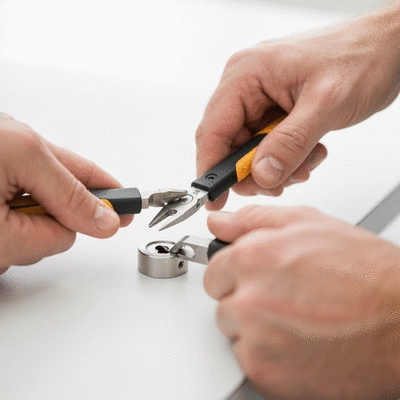 Modern locksmith using advanced tools to rekey a lock, close up, professional setting